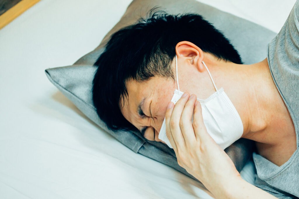 adult lying down with protective face mask 2026 03 18 04 57 59 utc